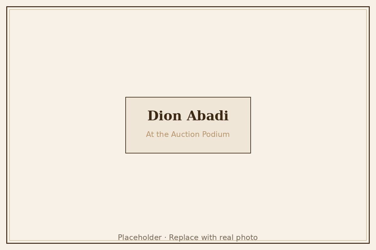 Dion Abadi at the auction podium — art and jewelry auctioneer